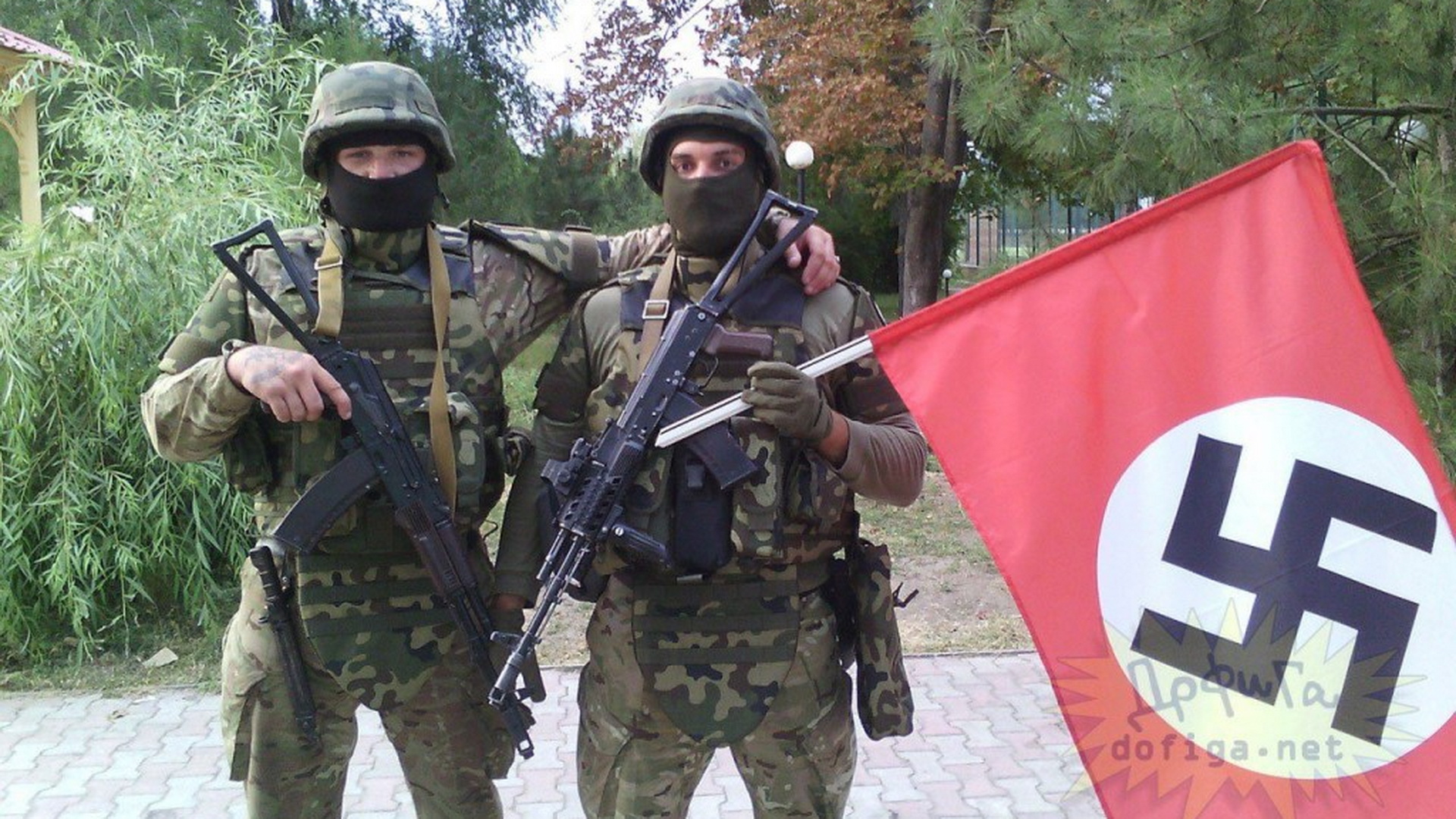 Ukrainian soldiers with a Nazi flag